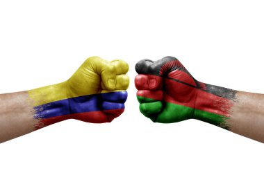 Two hands punch to each others on white background. Country flags painted fists, conflict crisis concept between colombia and malawi