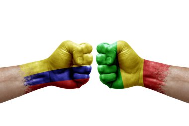 Two hands punch to each others on white background. Country flags painted fists, conflict crisis concept between colombia and mali