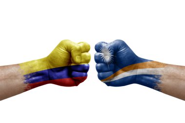 Two hands punch to each others on white background. Country flags painted fists, conflict crisis concept between colombia and marshall islands