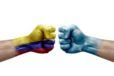 Two hands punch to each others on white background. Country flags painted fists, conflict crisis concept between colombia and micronesia