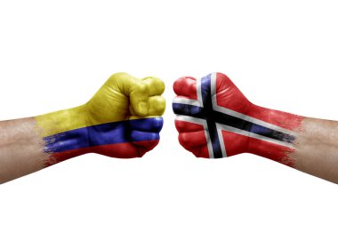 Two hands punch to each others on white background. Country flags painted fists, conflict crisis concept between colombia and norway