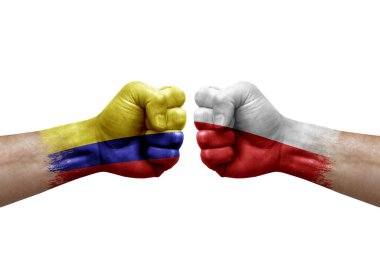 Two hands punch to each others on white background. Country flags painted fists, conflict crisis concept between colombia and poland