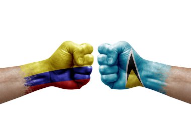 Two hands punch to each others on white background. Country flags painted fists, conflict crisis concept between colombia and saint lucia