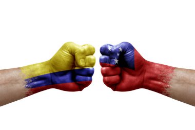Two hands punch to each others on white background. Country flags painted fists, conflict crisis concept between colombia and samoa