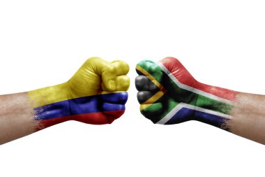 Two hands punch to each others on white background. Country flags painted fists, conflict crisis concept between colombia and south africa