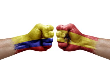Two hands punch to each others on white background. Country flags painted fists, conflict crisis concept between colombia and spain