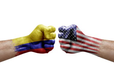 Two hands punch to each others on white background. Country flags painted fists, conflict crisis concept between colombia and usa