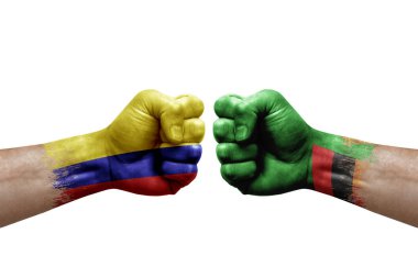 Two hands punch to each others on white background. Country flags painted fists, conflict crisis concept between colombia and zambia