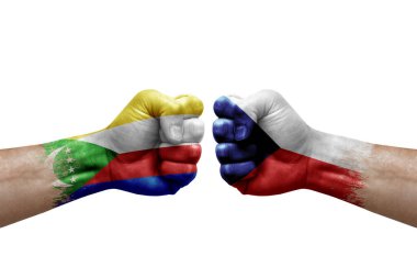 Two hands punch to each others on white background. Country flags painted fists, conflict crisis concept between comoros and czechia