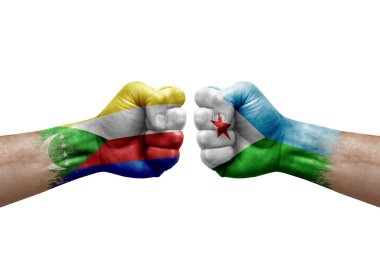 Two hands punch to each others on white background. Country flags painted fists, conflict crisis concept between comoros and djibouti