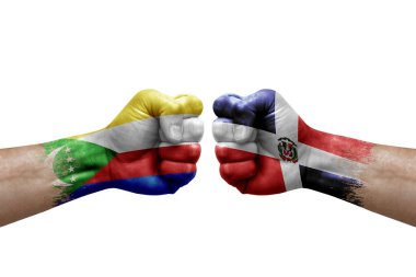 Two hands punch to each others on white background. Country flags painted fists, conflict crisis concept between comoros and dominican republic