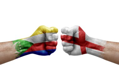 Two hands punch to each others on white background. Country flags painted fists, conflict crisis concept between comoros and england