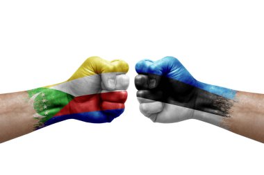 Two hands punch to each others on white background. Country flags painted fists, conflict crisis concept between comoros and estonia