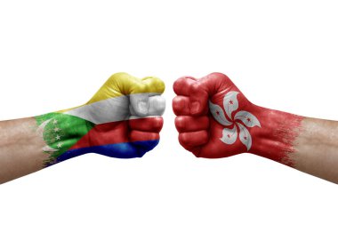 Two hands punch to each others on white background. Country flags painted fists, conflict crisis concept between comoros and hong kong