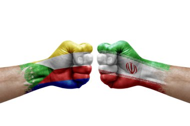 Two hands punch to each others on white background. Country flags painted fists, conflict crisis concept between comoros and iran