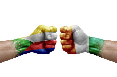 Two hands punch to each others on white background. Country flags painted fists, conflict crisis concept between comoros and ivory coast