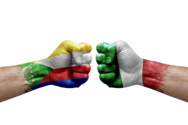 Two hands punch to each others on white background. Country flags painted fists, conflict crisis concept between comoros and italy