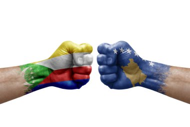 Two hands punch to each others on white background. Country flags painted fists, conflict crisis concept between comoros and kosovo