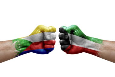 Two hands punch to each others on white background. Country flags painted fists, conflict crisis concept between comoros and kuwait