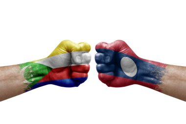 Two hands punch to each others on white background. Country flags painted fists, conflict crisis concept between comoros and laos