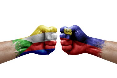 Two hands punch to each others on white background. Country flags painted fists, conflict crisis concept between comoros and liechtenstein