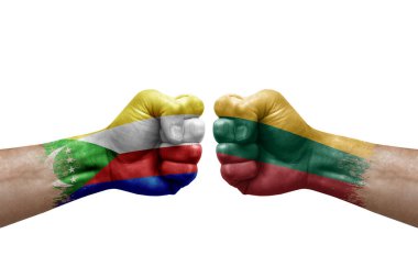 Two hands punch to each others on white background. Country flags painted fists, conflict crisis concept between comoros and lithuania