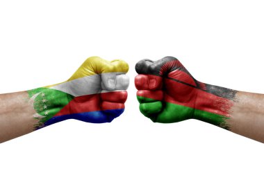 Two hands punch to each others on white background. Country flags painted fists, conflict crisis concept between comoros and malawi