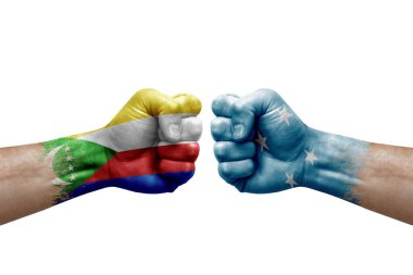 Two hands punch to each others on white background. Country flags painted fists, conflict crisis concept between comoros and micronesia