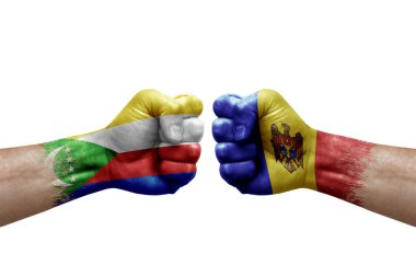 Two hands punch to each others on white background. Country flags painted fists, conflict crisis concept between comoros and moldova