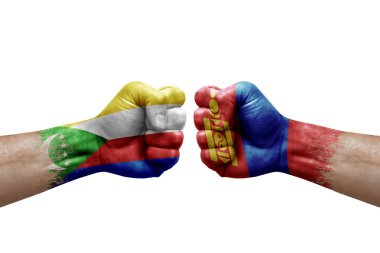 Two hands punch to each others on white background. Country flags painted fists, conflict crisis concept between comoros and mongolia