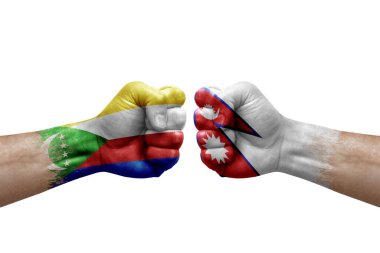 Two hands punch to each others on white background. Country flags painted fists, conflict crisis concept between comoros and nepal