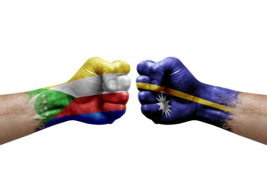 Two hands punch to each others on white background. Country flags painted fists, conflict crisis concept between comoros and nauru