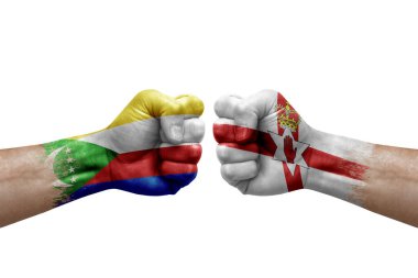 Two hands punch to each others on white background. Country flags painted fists, conflict crisis concept between comoros and ireland
