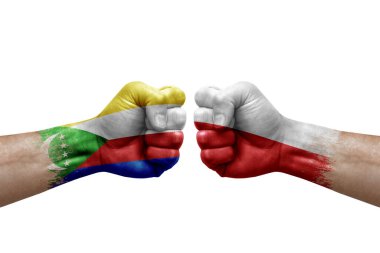 Two hands punch to each others on white background. Country flags painted fists, conflict crisis concept between comoros and poland