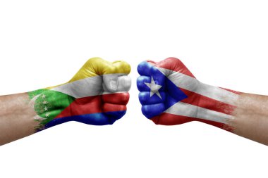 Two hands punch to each others on white background. Country flags painted fists, conflict crisis concept between comoros and puerto rico