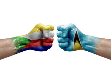 Two hands punch to each others on white background. Country flags painted fists, conflict crisis concept between comoros and saint lucia