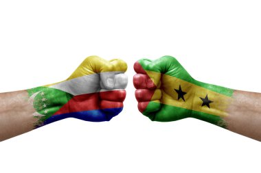Two hands punch to each others on white background. Country flags painted fists, conflict crisis concept between comoros and sao tome and principe