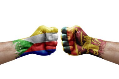 Two hands punch to each others on white background. Country flags painted fists, conflict crisis concept between comoros and sri lanka