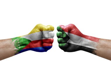 Two hands punch to each others on white background. Country flags painted fists, conflict crisis concept between comoros and sudan