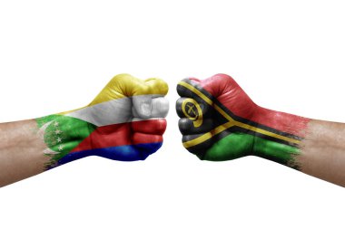 Two hands punch to each others on white background. Country flags painted fists, conflict crisis concept between comoros and vanuatu