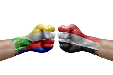 Two hands punch to each others on white background. Country flags painted fists, conflict crisis concept between comoros and yemen