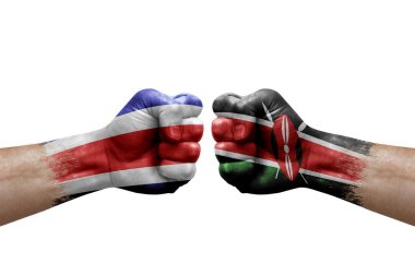 Two hands punch to each others on white background. Country flags painted fists, conflict crisis concept between costa rica and kenya