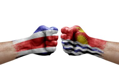 Two hands punch to each others on white background. Country flags painted fists, conflict crisis concept between costa rica and kiribati