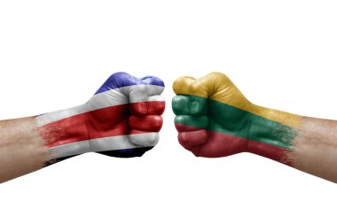 Two hands punch to each others on white background. Country flags painted fists, conflict crisis concept between costa rica and lithuania