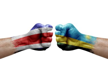 Two hands punch to each others on white background. Country flags painted fists, conflict crisis concept between costa rica and rwanda