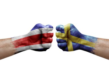 Two hands punch to each others on white background. Country flags painted fists, conflict crisis concept between costa rica and sweden