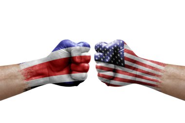 Two hands punch to each others on white background. Country flags painted fists, conflict crisis concept between costa rica and usa