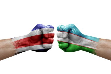 Two hands punch to each others on white background. Country flags painted fists, conflict crisis concept between costa rica and uzbekistan
