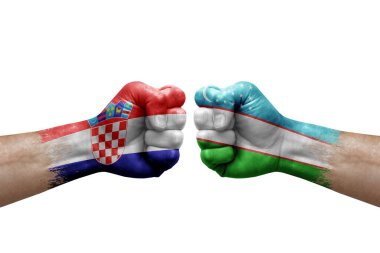 Two hands punch to each others on white background. Country flags painted fists, conflict crisis concept between croatia and uzbekistan