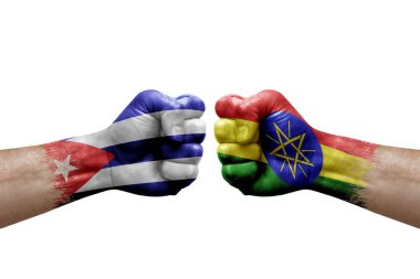 Two hands punch to each others on white background. Country flags painted fists, conflict crisis concept between cuba and ethiopia